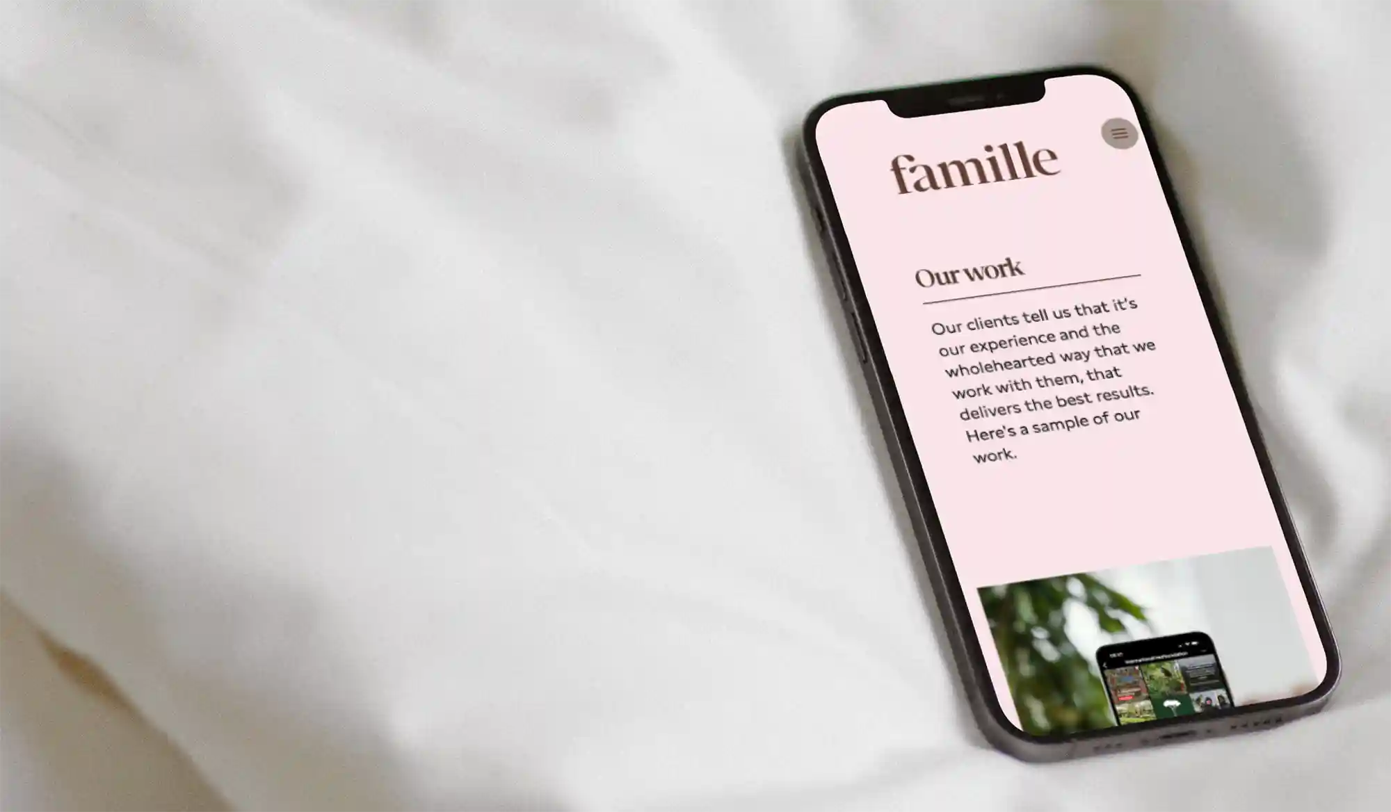 famille website on an iPhone on a bed